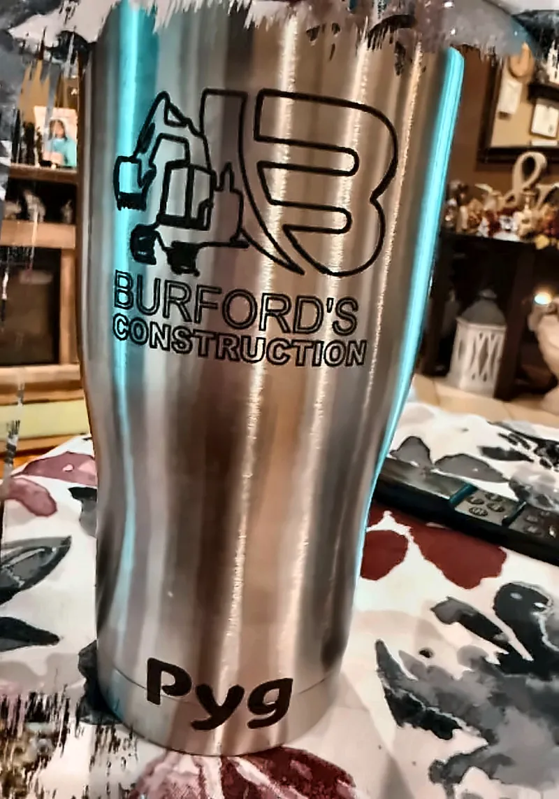 Stainless steel tumbler personalized with the Burford's Construction logo, an excavator graphic, and the name Pyg near the base